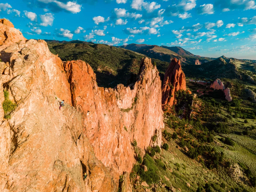View of rock climber on spires in garden of the gods