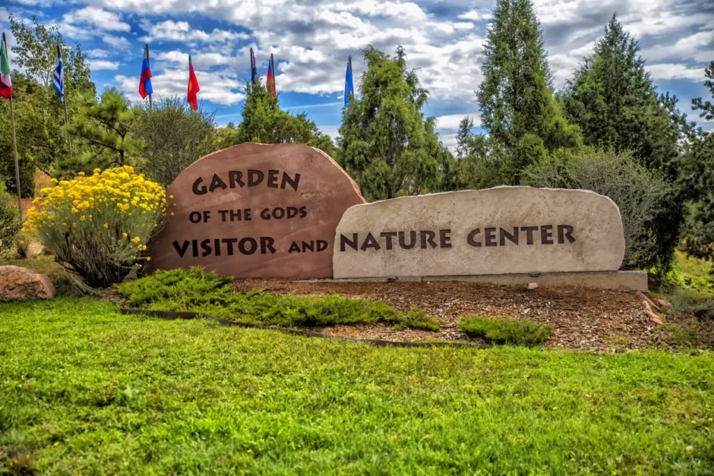 Visitor Center Signage with foliage around it