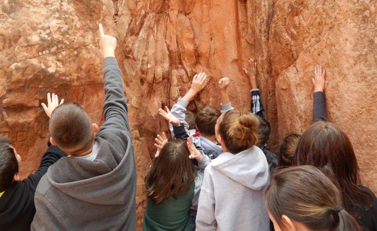 School field trip with kids pointing at the rocks